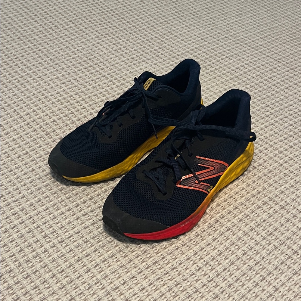 New Balance Black Running Shoes with Red and Yellow Accents